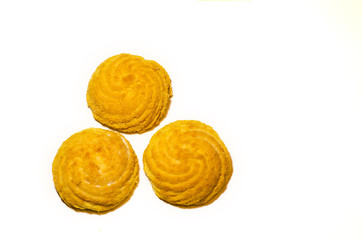 Three delicious round cookies lie on a white background in the shape of a triangle. Selective focus.