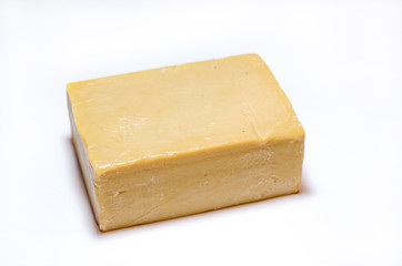 A piece of Laundry soap lies on a white background.