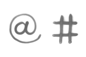 Graffiti email and hashtag sign sprayed on white isolated background