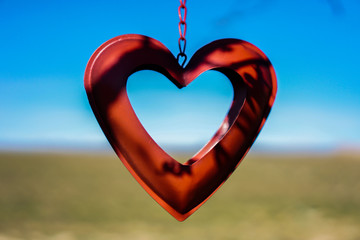 red heart in front of a blurred background