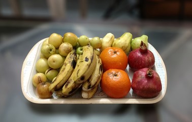 Fresh fruit like banana orange and pomegranate.