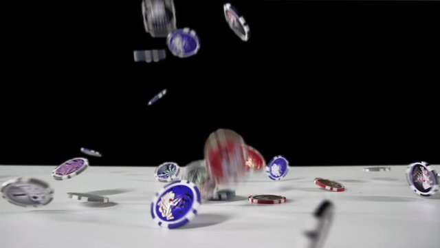 Wide angle: Colored Poker chips falling on the chromakey background, 4x rapid