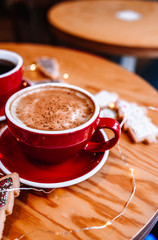 Cup of cappuccino with cinnamon and Christmas cookies