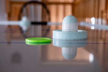 Close up of air hockey puck and table
