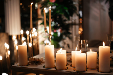 Burning candles. Beautiful composition of many burning candles on the table. Atmosphere