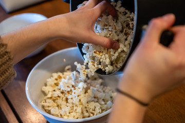 pouring popcorn out of pot