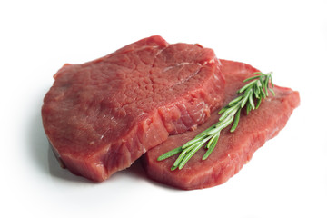 raw beef steak with rosemary isolated on white