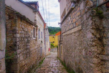 Fototapeta na wymiar Zlarin, Croatia / 18th May 2019: Old stone streets and pavement in Zlarin island near Sibenik