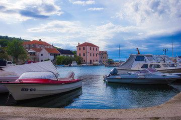 Zlarin, Croatia / 18th May 2019: Boats and old stone houses in Zlarin island near Sibenik