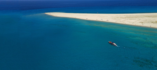 Aerial drone ultra wide photo of luxury yacht docked in tropical exotic turquoise beach