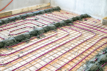 Installation of Underfloor heating, heated with antifreeze. Underfloor heating with heat transfer fluid. Cement screed with metal reinforcement