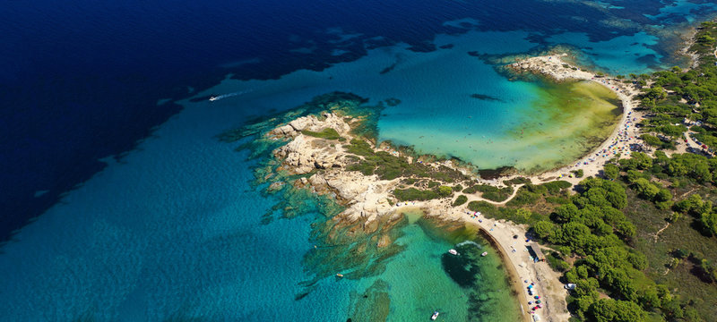 Aerial drone ultra wide photo of beautiful turquoise bay and beach of Kavourotripes with rocky seascape in Sithonia Peninsula, Halkidiki, Greece