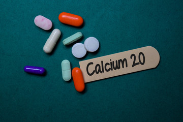 Calcium 20 write on stick note isolated on Office Desk. Medical concept