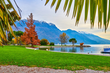 Beautiful and colorful autumn in Riva del Garda, Garda lake surrounded by mountains, Trentino Alto...