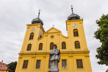 Fototapeta premium Osijek / Croatia: 10th May 2019: Saint Mihael church and Ivan Nepomuk statue inside medieval fortification tvrdja in Osijek