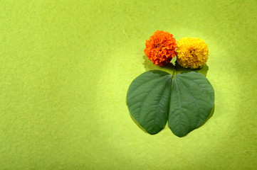 Indian Festival Dussehra, showing golden leaf and flowers on green background. Greeting card.