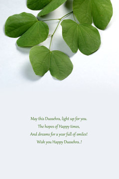 Indian Festival Dussehra, showing golden leaf on grey background. Greeting card.