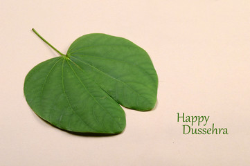 Indian Festival Dussehra, showing golden leaf . Greeting card.