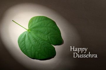 Indian Festival Dussehra, showing golden leaf . Greeting card.