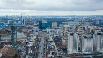 Fototapeta na wymiar Residential quarters, new building and the National Library. Construction of the Minsk Mayak neighborhood in Minsk.