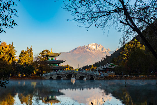 Black Dragon Pool with Jade Dragon Snow Mountain background, landmark and popular spot for tourists attractions near Lijiang Old Town. Lijiang, Yunnan, China