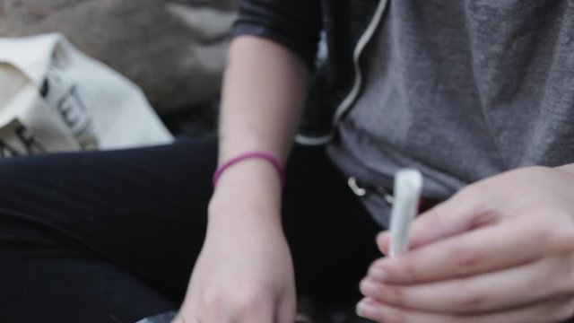 Toronto Canada - A Young Lady Showing How To Make A Marijuana Cigarette - Close Up Shot