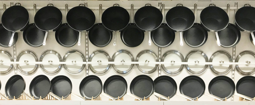 Hanging Teflon Pans And Lids On Wall