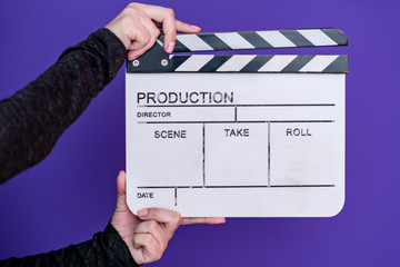movie clapper on purple violet background