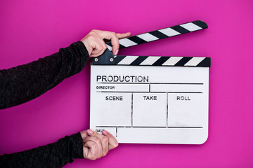 movie clapper on pink purple violet background