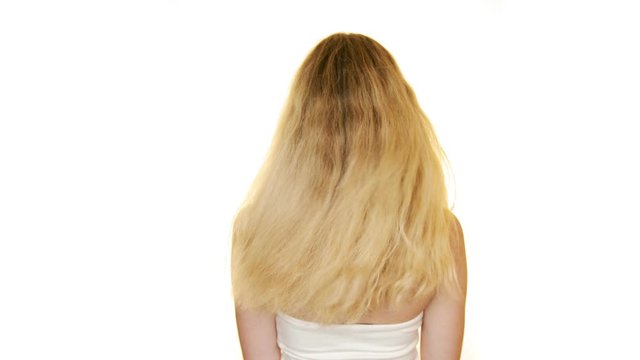 Shot of the back of a slim woman with long blond hair moving her hair. Isolated on white background. 4K,UHD
