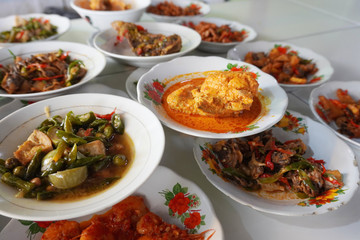 Nasi Padang is a Padang steamed rice served with various choices of pre-cooked dishes like seafood, vegetable and fermented tofu originated from Indonesia. 