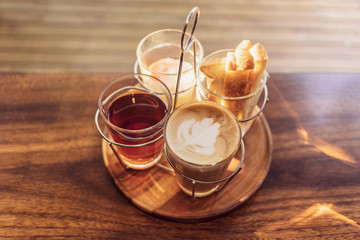Vintage hot coffee set with soft boiled eggs and toasted sticks on wooden table in morning sunlight