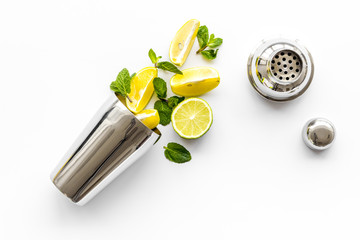 Bar background. Making cocktails concept. Shaker, lime on white background top-down copy space