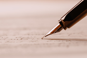Fountain pen on an ancient handwritten letter. Old story. Retro style.