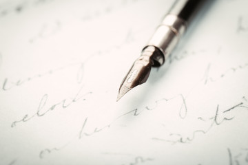 Fountain pen on an ancient handwritten letter. Old story. Retro style.