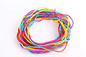 Colorful paper rope with knot isolated on white .