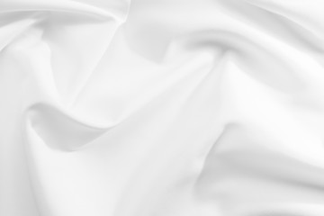 Abstract white fabric texture background. Cloth soft wave. Creases of satin, silk, and cotton.	