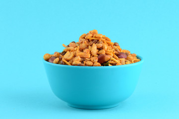 Indian Snacks : Mixture (roasted nuts with salt pepper masala, pulses, channa masala dal green peas) in blue bowl in