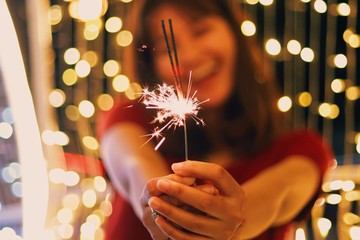 young woman with Sparkle fireworks in Christmas party.