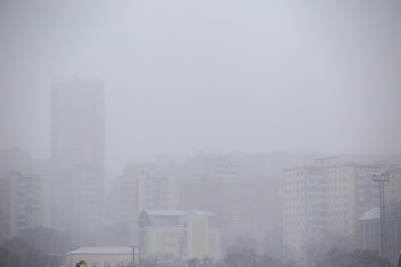 Fototapeta na wymiar Fog in the city of Vladivostok. High-rise new residential buildings in the fog.