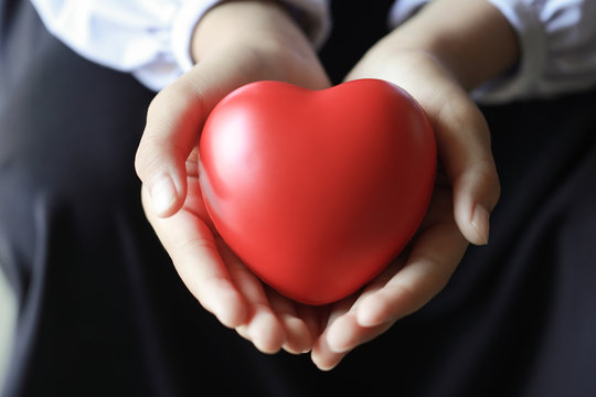 Red heart in hand.