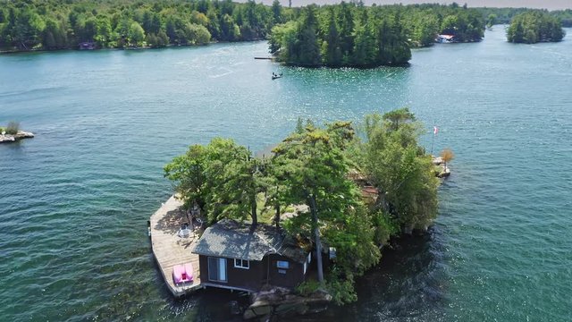 Aerial: Vacation homes on remote islands in the St Lawrence River. Thousand Islands, Ontario, Canada. 13 September 2019