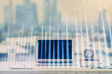 Forex Chart hologram on table with computer background. Multi exposure. Concept of financial markets.