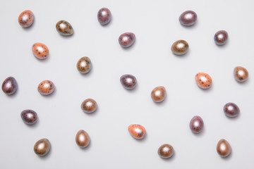 Pastel pearl Easter eggs on pastel blue background.