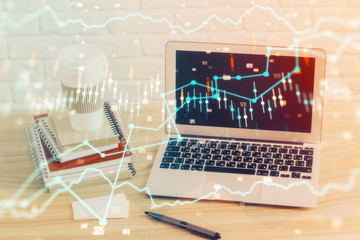 Financial market graph hologram and personal computer on background. Multi exposure. Concept of forex.