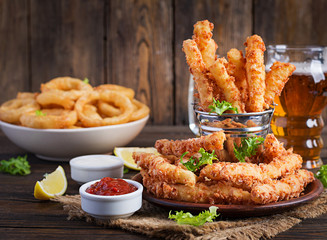 Cheese sticks  and onion rings in batter with sauce. Beer snacks. Copy spase