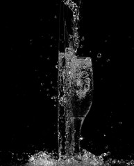 splash and spatter of water in a glass on a black background