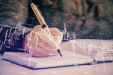 Multi exposure of woman's hands making notes with forex graph hologram. Concept of technical analysis.