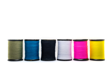 Colorful of cotton sewing thread isolated on white background. Concept for tailor equipment ,Needlework ,Garment shop.