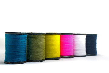 Colorful of cotton sewing thread isolated on white background. Concept for tailor equipment ,Needlework ,Garment shop.